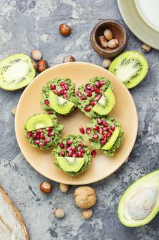 Diet avocado cupcakes garnished with kiwi and pomegranate