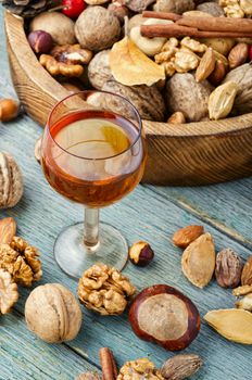 Shot glass with aromatic alcohol from nuts.Nut liquor.Tincture on nuts.Nut flavoring