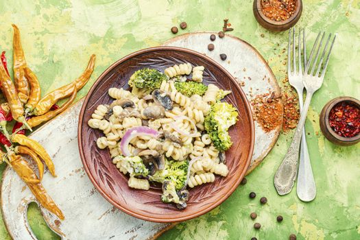 Italian pasta farfalle with broccoli and mushrooms.Italian food