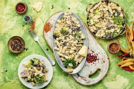 Baked broccoli and pasta with mushrooms.Italian food