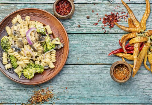 Italian pasta farfalle with broccoli and mushrooms.Italian food