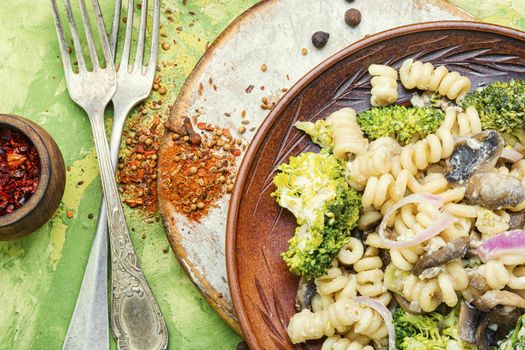 Baked broccoli and pasta with mushrooms.Italian food