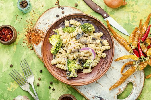 Baked broccoli and pasta with mushrooms.Italian food