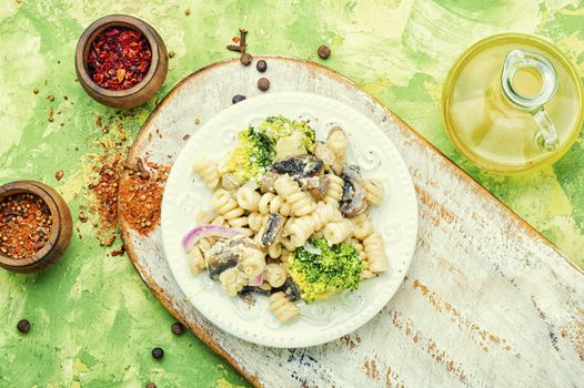 Baked broccoli and pasta with mushrooms.Italian food