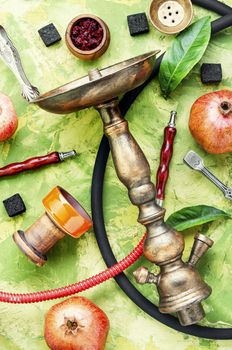 Turkish smoking hookah.Hookah with tobacco with pomegranate flavor.Hookah concept.Trendy hookah