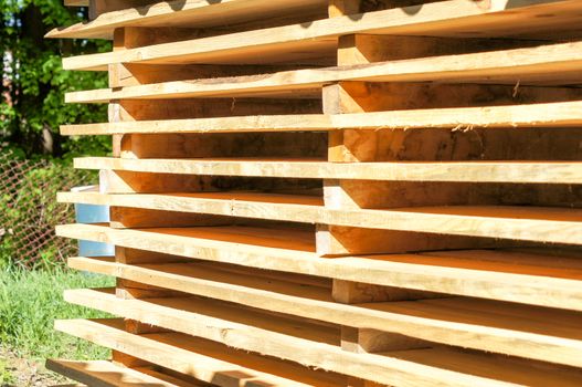 Wooden pallets stacked in the open air. For your design