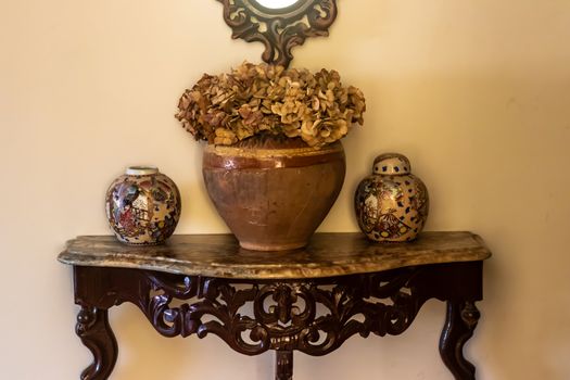 yellow color dominated good composed shoot from some antique items. there is some vases, containers and table.