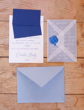 Wedding details flat lay on wooden background. Wedding invitation. Wedding bouquet. Copy space. Mock up. Envelope.