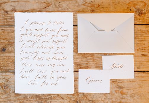 Wedding details flat lay on wooden background. Wedding invitation. Wedding bouquet. Copy space. Mock up. Envelope.