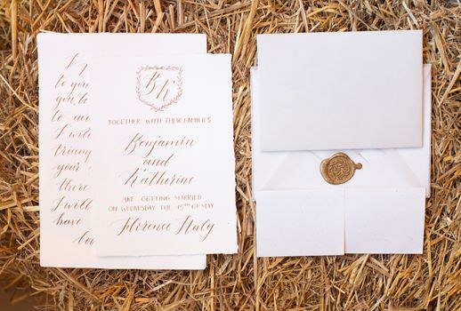 Wedding details flat lay on wooden background. Wedding invitation. Wedding bouquet. Copy space. Mock up. Envelope.