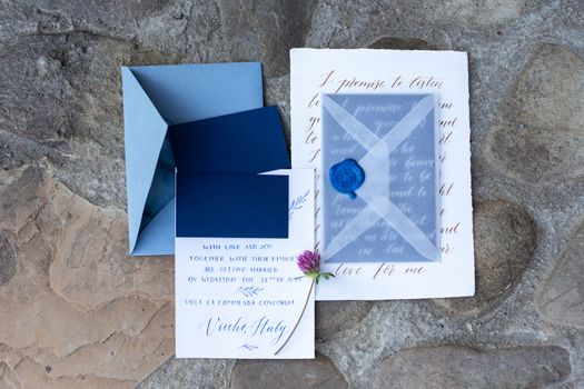 Wedding details flat lay on stone background. Wedding invitation. Ring box. Copyspace. Mock up.