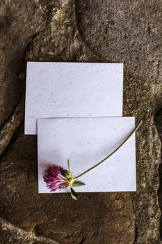 Wedding details flat lay on stone background. Wedding invitation. Ring box. Copyspace. Mock up. Clover