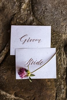 Wedding details flat lay on stone background. Wedding invitation. Ring box. Copyspace. Mock up. Clover