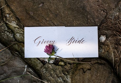 Wedding details flat lay on stone background. Wedding invitation. Ring box. Copyspace. Mock up. Clover