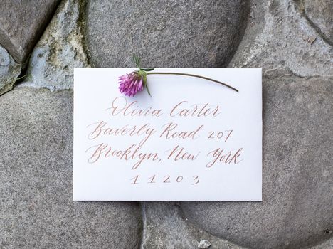 Wedding details flat lay on stone background. Wedding invitation. Ring box. Copyspace. Mock up. Clover