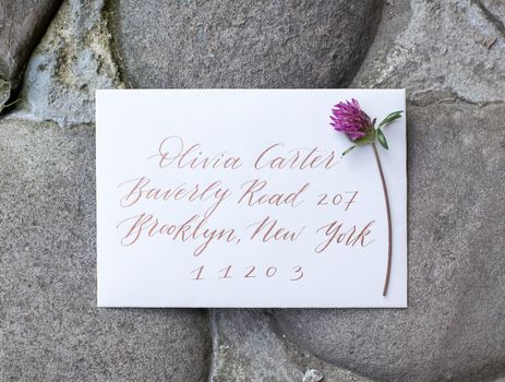 Wedding details flat lay on stone background. Wedding invitation. Ring box. Copyspace. Mock up. Clover