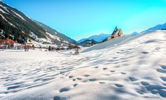 Mountain landscape, picturesque snow footprints in the winter morning panoramic church .
