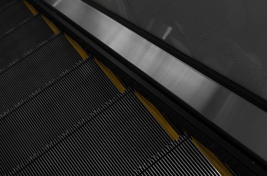 Modern escalator electronic system moving. Escalator is moving up.The ground is a straight line. Black with yellow band