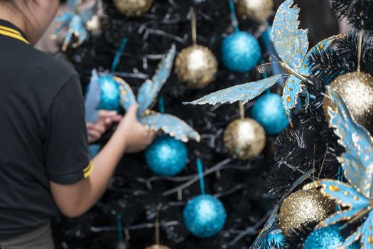 Decorated Christmas tree with a blue and gold toys and beautiful blue butterfly toy. Holidays. Preparation for New Year and Christmas