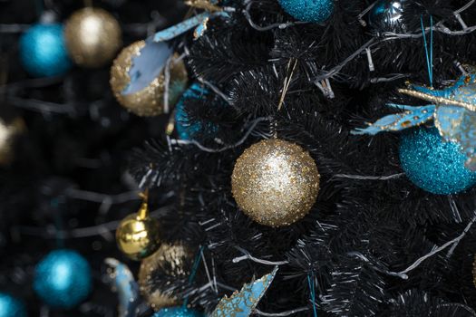 Decorated Christmas tree with a blue and gold toys and beautiful blue butterfly toy. Holidays. Preparation for New Year and Christmas