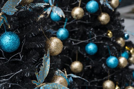 Decorated Christmas tree with a blue and gold toys and beautiful blue butterfly toy. Holidays. Preparation for New Year and Christmas