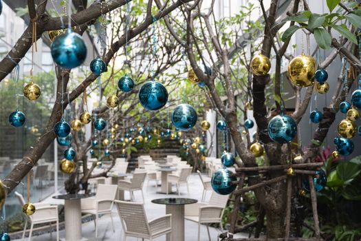 Decorated Christmas tree with a blue and gold toys and beautiful blue butterfly toy. Holidays. Preparation for New Year and Christmas