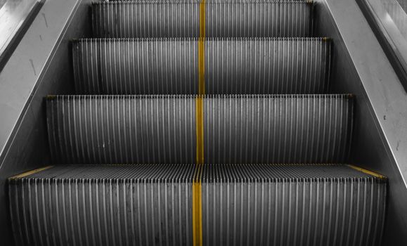 Ditry stairs on Escalator with yellow strips