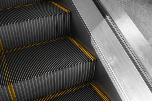 Ditry stairs on Escalator with yellow strips