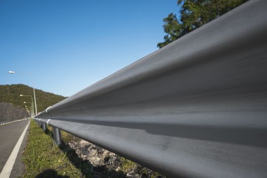 Safety steel barrier on freeway bridge designed to prevent the exit of the vehicle from the curb or bridge