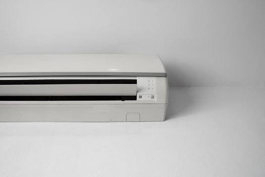 Air conditioner mounted on a white wall in the living room or bedroom. Indooor comfort temperature. Health concepts and energy savings