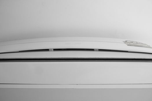 Air conditioner mounted on a white wall in the living room or bedroom. Indooor comfort temperature. Health concepts and energy savings