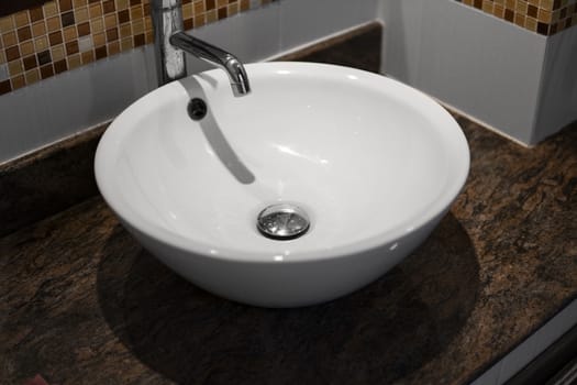 Round white sink in the bathroom