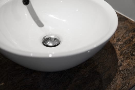 Round white sink in the bathroom