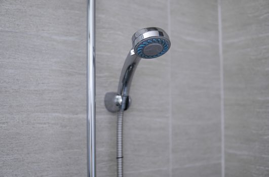 Modern shower head in modern bathroom. Shower head in bathroom with water spray or water flow. Feeling relax and enjoy in private bathroom. Fresh water flow from shower head for cleaning body dirty