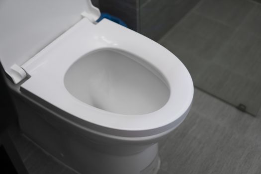 White toilet in modern home. White toilet bowl in bathroom