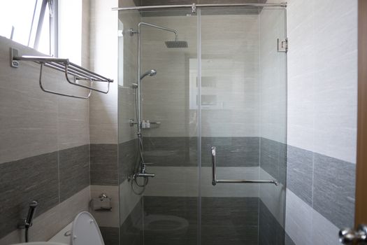 Shower cabin with a glass walls and door in a modern bathroom