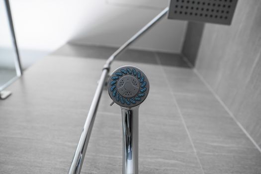Square shower head and classic shower head in a modern bathroom. Shower in the bathroom with water spray or water. A stream of fresh water from the shower head to clean the dirty body
