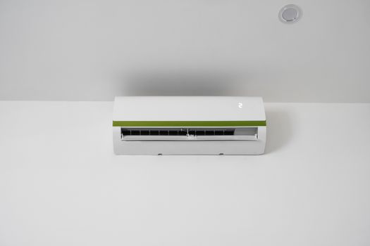 Air conditioner mounted on a white wall in the living room or bedroom. Indooor comfort temperature. Health concepts and energy savings