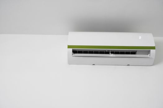 Air conditioner mounted on a white wall in the living room or bedroom. Indooor comfort temperature. Health concepts and energy savings