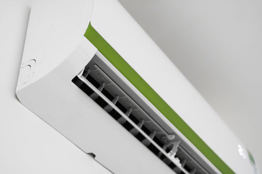 Air conditioner mounted on a white wall in the living room or bedroom. Indooor comfort temperature. Health concepts and energy savings