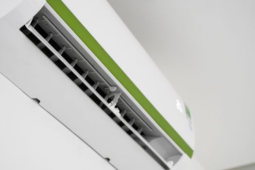 Air conditioner mounted on a white wall in the living room or bedroom. Indooor comfort temperature. Health concepts and energy savings