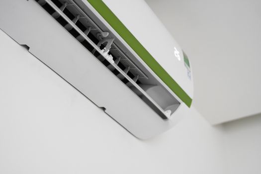 Air conditioner mounted on a white wall in the living room or bedroom. Indooor comfort temperature. Health concepts and energy savings