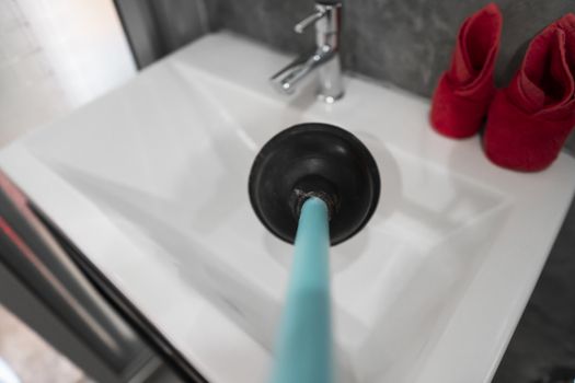 Toilet repair by hand with a Toilet Plunger. Plumbing. A plumber uses a plunger to unclog a toilet. Toilet Plunger