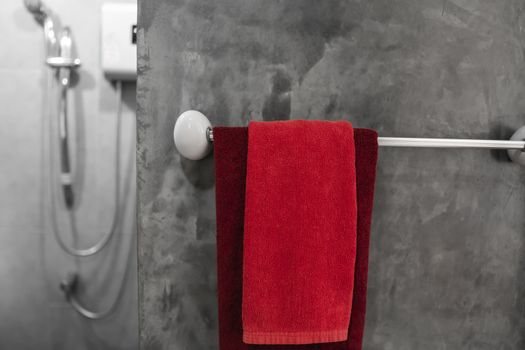 One red towel in bathroom on a dryer. Counter bathroom interior contemporary. Luxury and stylish design bathroom with a concrete style walls