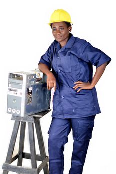Young woman smiling in uniform standing, elbow on a desktop disassembled