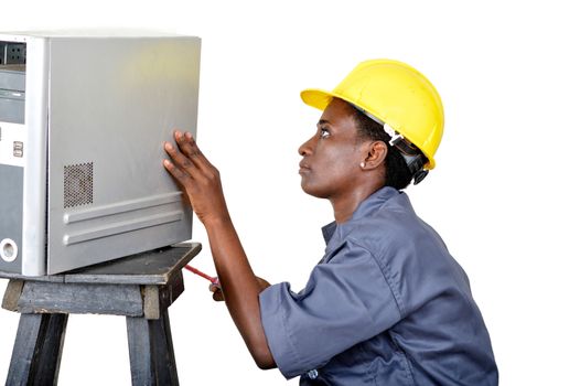 Close-up of a young woman doing the maintenance of a desktop computer.