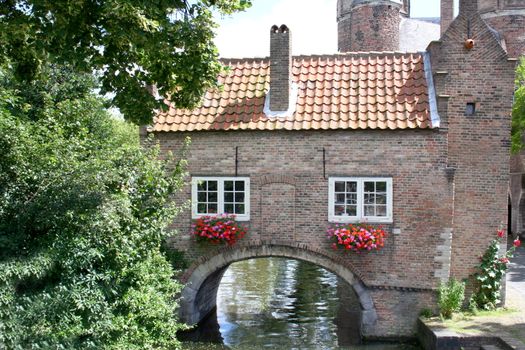 Romantic house with archway over a watercourse