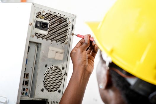 Close-up of a worker's head opening a computer with a vice turn.