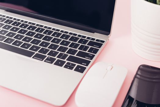 Top view of modern technology smart phone mobile and computer laptop on pink background with copy space