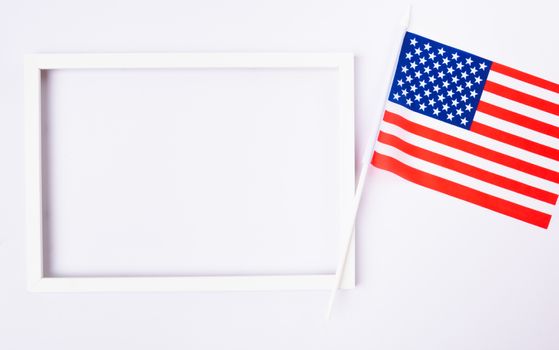 Martin luther king day, flat lay top view, American flag and photo frame on white background with copy space for your text
